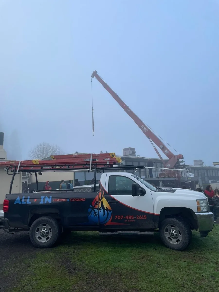 All In Heating and Cooling truck during a commercial rooftop HVAC installation